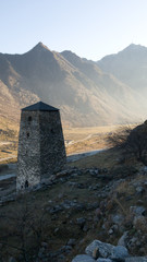 Beautiful view of the old watchtower in the settlement of Upper Balkaria in Kabardino-Balkaria in the Caucasus in Russia. Stunning sunset in the mountains