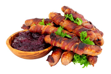 Pigs in blankets with a bowl of cranberry sauce dip isolated on a white background