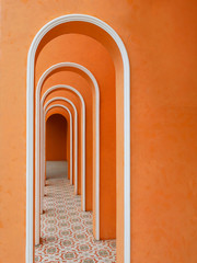 Architectural arches corridor orange color with empty wall and arabic tile pattern.