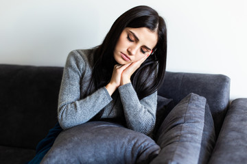 Fototapeta premium Sick woman, Flu woman. Caught Cold. Young beautiful woman with a throat pain feel sick in the couch