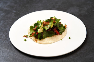 Mexican tacos with beef, tomatoes, avocado, chilli and onion