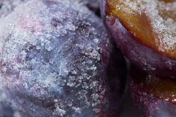  Close up fresh frozen blue plums background