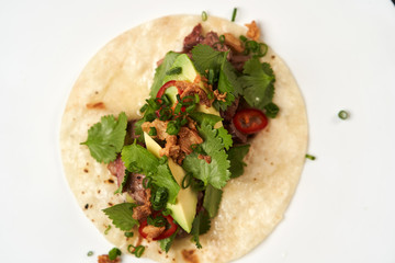 Mexican tacos with beef, tomatoes, avocado, chilli and onion