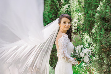 beautiful bride with flying veil outside