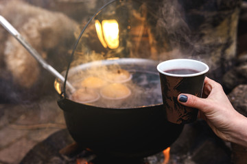 Bowl with a mulled wine on the open fire