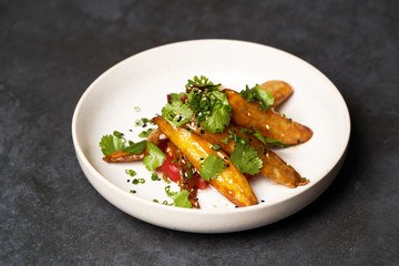 Crispy eggplant with tomatoes and sweet chili sauce, close-up