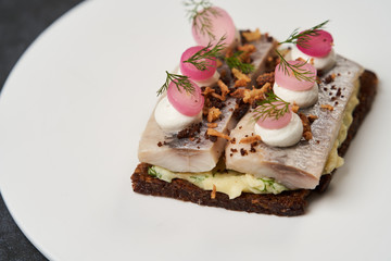 Smorrebrod with Baltic herring fish, smoked mousse and pickled onions