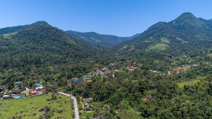 Aerial view to the mountaineous green hinterland of Tarituba on a sunny day, Green coast, Brazil