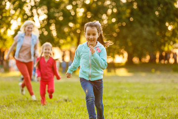 Summer fun. little girls play in the field