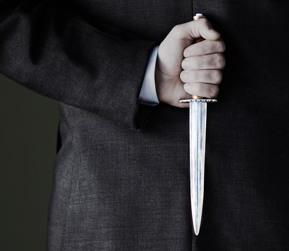 Midsection Of Businessman Holding Knife