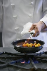 Midsection Of Chef Cooking Food