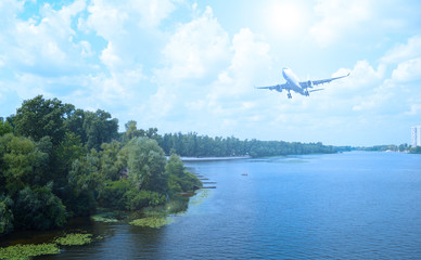 The plane over the forest and the river. The evening is cold.