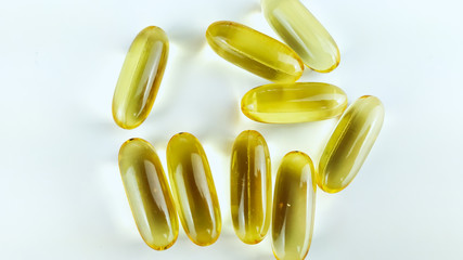 Closeup of many omega pills capsules placed on white background table as healthy and natural...