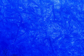 blue texture of an ice surface with pure azure water ,cold clear snow cryslallized wall background ,winter frozen lake side close up , abstract macro wallpaper