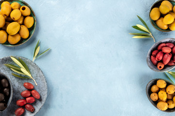 Olives, overhead panoramic shot. Black, green and red olives of various sizes, shot from above, a flatlay design template with copyspace