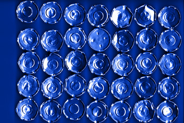 metal circles on a blue background with blue backlight