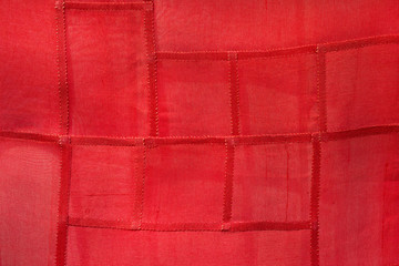 Fototapeta premium Red fabrics with red thread stitching.