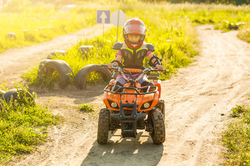 Little girl riding ATV quad bike in race track © Angelov