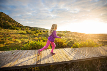 Girl on boardwalk - Powered by Adobe