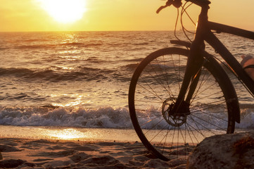 Bicycle on the seashore. Sunset on the sea and Bicycle.