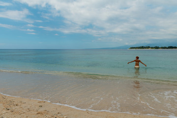 Fototapeta na wymiar Woman at tropical island beach