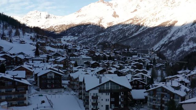 Jib up of idyllic mountain town in winter