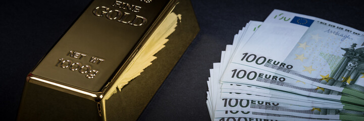 Euro cash and gold bar on a black background. Banknotes. Money. Bill. Ingot. Bullion.
