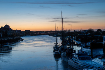 Sunrise behind the River Arun Littlehampton with yachts and boats in the foreground.
