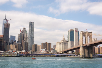 Fototapeta na wymiar View of Manhattan's East Side and the Brooklyn Bridge City Hall across the Hudson River. Taken near Brooklyn Bridge on September the 28th, 2019
