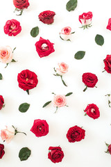 Floral composition with red, pink rose flower buds and leaves pattern texture on white background. Flatlay, top view.