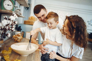 Family is preparing food at home. Little boy in a kitchen