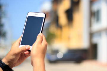 hand holding smart phone with blank screen