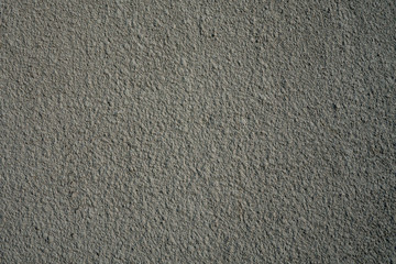 Rough gray painted plaster or stucco wall. Abstract grunge background with copy space.