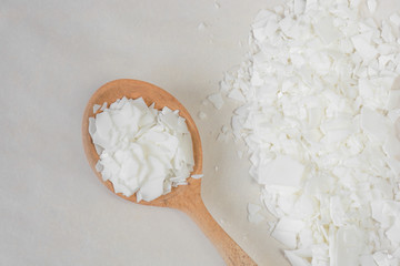 Close up of white soy wax flakes for candle making. Light texture of soy wax flakes. Ingredient for...