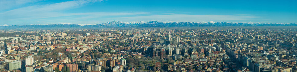 Fototapeta na wymiar Aerial view of Milan (Italy) with the Lombard Alps in the background