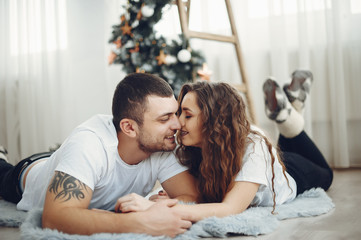 Couple at home. Brunette in a cute sweater.