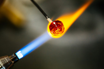 Close-up of glass bead melting in gas-burner fire