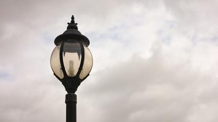 lamp post,Decorative street lamp-post,Retro street lamp shining at night against cloudy sky,Round...