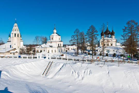 Church of the Resurrection (1680) and Assumption Church (1775) with a bell tower in the form of a pencil in the village Luh/ Ivanovo region/ Russia/ Winter landscape