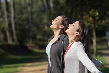 Two happy friends breathing fresh air together