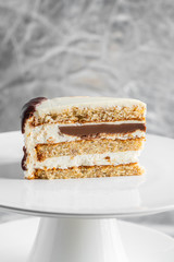 piece of cake with cream on a white plate