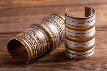 Beautiful wide bracelets close-up. Indian copper bracelets with gold ornaments. Ritual bracelets...