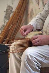 craftsman creates a wicker basket