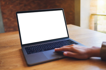 Mockup image of a woman using and touching on laptop touchpad with blank white desktop screen