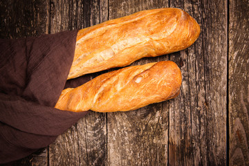 Top view of french baguette bread. Fresh baguettes on wooden table. Bread shop.