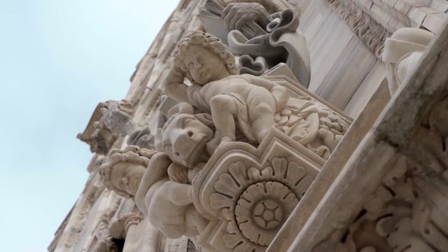 Statues and sculptures on the Duomo of Milan facade, Italy. Concept of classical artwork in Italy.