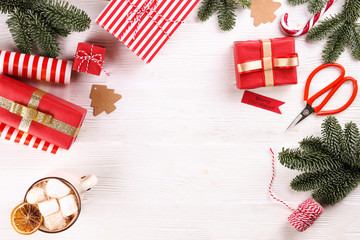Getting ready for winter holiday season, wrapping presents and preparing decorations on wooden...