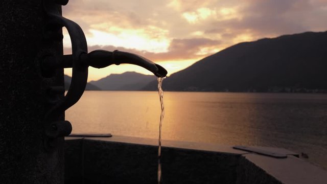 Lugano Lake. Fountain Slow Motion in Bissone, tiny village on the lake