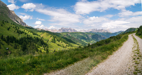 High top mountain dirt road, mountains on background, off road, beautiful view, danger road in mountains, extreme. Passo Pordoi, Italy
