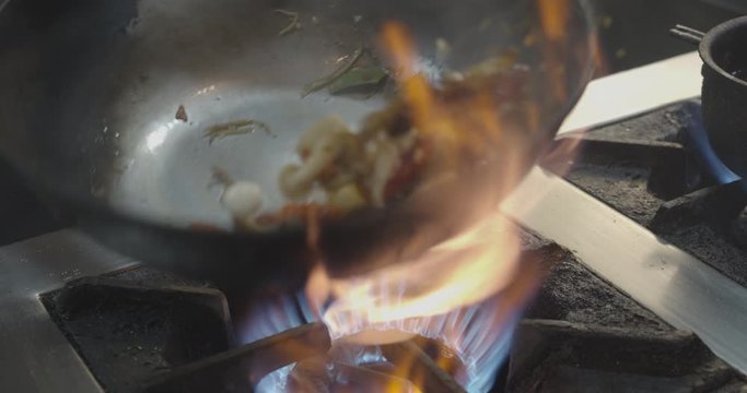 Cooking thai food fried vegetable in a wok at a restaurant in MBK Center in Bangkok - Delicious food - Illustrative swing Wok  - Close up